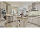 Open kitchen with stainless steel dishwasher, butcher block island, and access to the outdoor dining space at 100 Old Plantation Way, Fayetteville, GA 30214