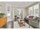Bright living room showcasing a staircase, hardwood floors, neutral tones, and a cozy seating arrangement at 100 Old Plantation Way, Fayetteville, GA 30214