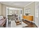 Inviting living room featuring hardwood floors, comfortable seating, and seamless flow into the dining area at 100 Old Plantation Way, Fayetteville, GA 30214