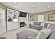 Cozy living room with built-in bookshelves, a fireplace, and a large gray sectional sofa at 100 Old Plantation Way, Fayetteville, GA 30214