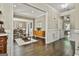 Open-concept living room flowing into the dining area with hardwood floors at 100 Old Plantation Way, Fayetteville, GA 30214