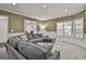 Bright living room featuring a large sectional sofa and large windows with natural light at 100 Old Plantation Way, Fayetteville, GA 30214