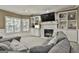 Inviting living room features a cozy fireplace, built-in shelves, and comfortable seating at 100 Old Plantation Way, Fayetteville, GA 30214