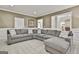 Spacious living room with a large sectional sofa, neutral carpet, and views of the kitchen at 100 Old Plantation Way, Fayetteville, GA 30214