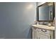 Charming powder room with a custom vanity and decorative mirror at 100 Old Plantation Way, Fayetteville, GA 30214
