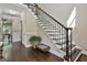 Elegant staircase with wood treads, decorative iron railing, and natural light at 100 Old Plantation Way, Fayetteville, GA 30214