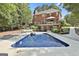 Backyard swimming pool with volleyball net and lounge area by a beautiful brick home at 100 Old Plantation Way, Fayetteville, GA 30214