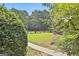 Well maintained and manicured front yard area showing grass, walkway and mature landscaping at 100 Old Plantation Way, Fayetteville, GA 30214