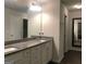 Bathroom with granite countertops, double sinks, and a large mirror at 85 Crabapple Ridge Dr, Oxford, GA 30054