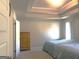 Bright bedroom with a tray ceiling, hardwood floors, and natural light at 85 Crabapple Ridge Dr, Oxford, GA 30054