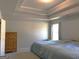 Bedroom with tray ceilings and a cozy blue comforter on the bed at 85 Crabapple Ridge Dr, Oxford, GA 30054
