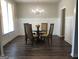 Dining room with wainscoting, modern light fixture, and a glass top table at 85 Crabapple Ridge Dr, Oxford, GA 30054