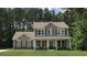 Charming two-story home featuring a welcoming front porch and a beautifully landscaped lawn with a basketball hoop at 85 Crabapple Ridge Dr, Oxford, GA 30054