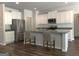 Modern kitchen featuring stainless steel appliances, granite countertops, a kitchen island, and stylish hardwood floors at 85 Crabapple Ridge Dr, Oxford, GA 30054