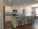 Bright kitchen featuring granite countertops, a central island with bar seating, and hardwood floors at 85 Crabapple Ridge Dr, Oxford, GA 30054
