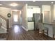Open concept kitchen with stainless steel appliances, hardwood floors, and easy access to the front entry and stairwell at 85 Crabapple Ridge Dr, Oxford, GA 30054