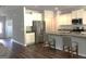 Modern kitchen featuring stainless steel appliances, granite countertops, a kitchen island, and stylish hardwood floors at 85 Crabapple Ridge Dr, Oxford, GA 30054