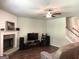 Bright and spacious living room featuring hardwood floors, a stone fireplace, and a comfortable seating area at 85 Crabapple Ridge Dr, Oxford, GA 30054