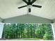 Relaxing outdoor porch area with ceiling fan, offering a serene view of the lush backyard at 85 Crabapple Ridge Dr, Oxford, GA 30054