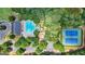 Aerial view of community pool, clubhouse, tennis courts, playground, parking, and surrounding trees at 48 Star Spangled Ln, Peachtree City, GA 30269