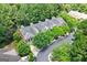 A high angle of townhomes in a community surrounded by lush trees and winding roads at 48 Star Spangled Ln, Peachtree City, GA 30269