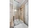 Bathroom shower with glass door and tile surround, featuring built in soap holders at 48 Star Spangled Ln, Peachtree City, GA 30269