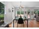 Bright dining area features wood floors, a glass-top table, and contemporary light fixture at 48 Star Spangled Ln, Peachtree City, GA 30269
