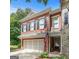 Charming two-story brick home featuring black shutters, a two-car garage, and manicured front yard at 48 Star Spangled Ln, Peachtree City, GA 30269