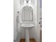Chic half bathroom with pedestal sink, decorative mirror, and modern fixtures at 48 Star Spangled Ln, Peachtree City, GA 30269