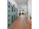 Hallway with hardwood floors and view into living room and powder room at 48 Star Spangled Ln, Peachtree City, GA 30269