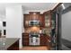 Modern kitchen with stainless steel appliances, wood cabinets, and tile backsplash at 48 Star Spangled Ln, Peachtree City, GA 30269