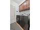 Practical laundry room featuring modern washer and dryer units and storage cabinets at 48 Star Spangled Ln, Peachtree City, GA 30269