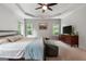 Bright main bedroom features neutral carpet, tray ceiling, large windows and stylish decor at 48 Star Spangled Ln, Peachtree City, GA 30269