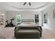 Spacious main bedroom with tray ceilings, carpet floors, and bright, large windows at 48 Star Spangled Ln, Peachtree City, GA 30269