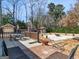 Beautiful backyard featuring a spacious patio with a fire pit and lush landscaping at 200 Magnolia Ct, Mcdonough, GA 30252