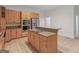 Well-equipped kitchen with tile floors, wood cabinetry, stainless steel appliances and center island at 95 Fern Ct, Stockbridge, GA 30281