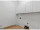 Functional laundry room with white cabinets and tile flooring, ready for appliances and utility connections at 95 Fern Ct, Stockbridge, GA 30281