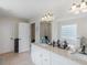 Bathroom showcasing a double vanity with granite countertops, tile flooring, and ample natural light at 2110 Mcgarity Rd, Mcdonough, GA 30252