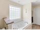 Relaxing bathroom featuring a soaking tub and a privacy window at 2110 Mcgarity Rd, Mcdonough, GA 30252