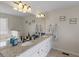 Bright bathroom featuring a granite double vanity and stylish lighting at 2110 Mcgarity Rd, Mcdonough, GA 30252