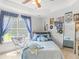 Charming bedroom with a ceiling fan, soft natural light, and whimsical decor at 2110 Mcgarity Rd, Mcdonough, GA 30252