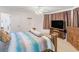 Bedroom with neutral carpet, ceiling fan, and comfortable furnishings at 2110 Mcgarity Rd, Mcdonough, GA 30252