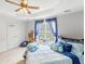 Inviting bedroom features a ceiling fan, cozy chair, and lots of whimsical pillows at 2110 Mcgarity Rd, Mcdonough, GA 30252