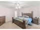 Bedroom featuring neutral carpet, ceiling fan, and a large wood-framed bed at 2110 Mcgarity Rd, Mcdonough, GA 30252