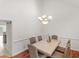 Dining room features stylish chandelier lighting, hardwood floors, and seating for six at 2110 Mcgarity Rd, Mcdonough, GA 30252