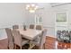 Dining room boasts hardwood floors, decorative chandelier, and natural light from windows at 2110 Mcgarity Rd, Mcdonough, GA 30252