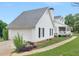 Charming home featuring a large garage, inviting front porch, lush landscaping, and a well-manicured lawn at 2110 Mcgarity Rd, Mcdonough, GA 30252