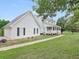 Exterior view of a charming white home with well-maintained landscaping and a two-car garage at 2110 Mcgarity Rd, Mcdonough, GA 30252