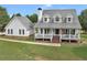 Charming two-story home with a large front porch, American flag, and well-maintained lawn at 2110 Mcgarity Rd, Mcdonough, GA 30252