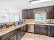 Well-maintained kitchen featuring dark cabinets, neutral countertops and tiled floor at 2110 Mcgarity Rd, Mcdonough, GA 30252
